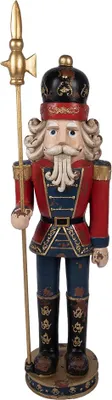 A nutcracker figure standing on a circular base, holding a spear.