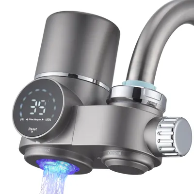 A close-up of a modern faucet water filter with a digital display and blue light emanating from the spout.