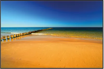 Produktbild von Wallario Wandbild Sandstrand in orange - Blaues Meer - Blauer Himmel, Größe: 61 x 91,50 cm, Poster mit schwarzem Aluminiumrahmen