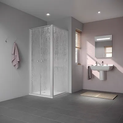 A modern bathroom with a shower cabin, sink, and mirror.