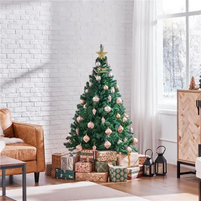 A decorated Christmas tree with presents underneath, in a living room setting.