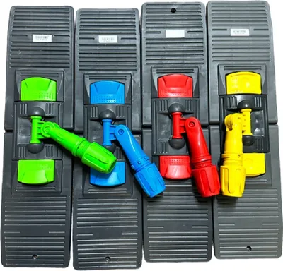 Four mop holders with colored handles are arranged in a row.