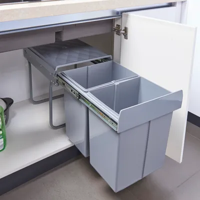 A pull-out trash bin system installed under a kitchen counter.
