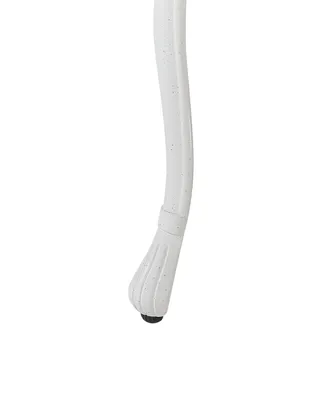 A close-up of the bottom of a white chair leg with a black foot.
