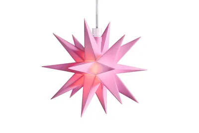 A pink star-shaped lamp hanging against a white background.