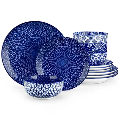 A set of blue and white patterned ceramic plates and bowls stacked and arranged on a white background.