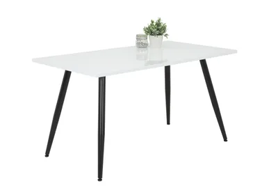 A white dining table with black legs is shown against a white background. A small potted plant and a glass are placed on the table.