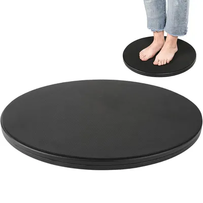 A black rotating disc with a person's feet standing on it, shown in the background. The main focus is the disc itself.
