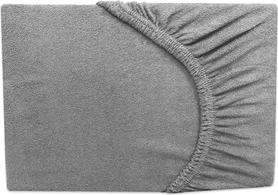 A close-up view of a grey fitted sheet with elastic gathering at the corner.