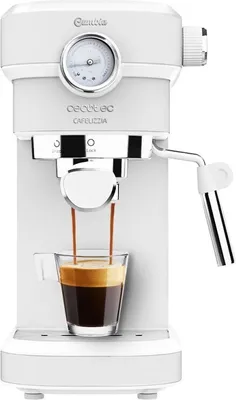 A white espresso machine is brewing coffee into a clear glass cup.