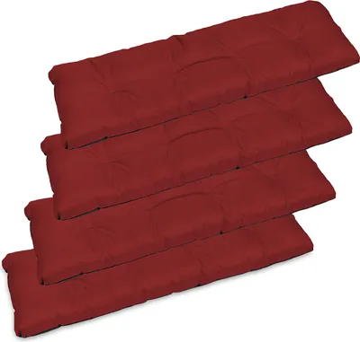 Four red seat cushions are stacked on top of each other, angled diagonally.