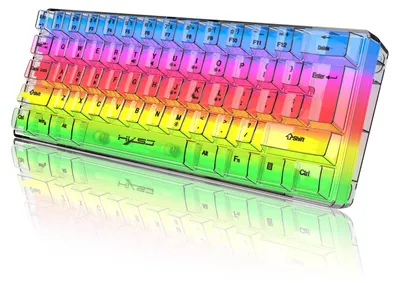 A transparent, rainbow-colored mechanical keyboard with RGB backlighting is shown from a slightly elevated, diagonal angle, with its reflection visible below on a white surface.