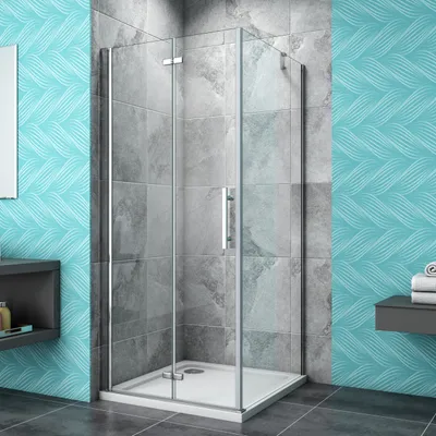 A modern bathroom with a glass shower enclosure, tiled walls, and decorative wallpaper.