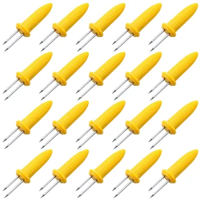 A grid of yellow corn holders with silver prongs against a white background.