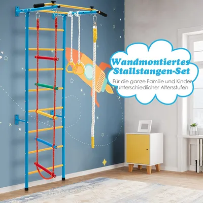 A children's indoor climbing frame mounted on a blue wall with a rocket ship mural.