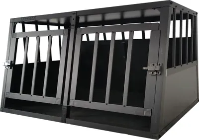A black metal dog crate with two compartments.