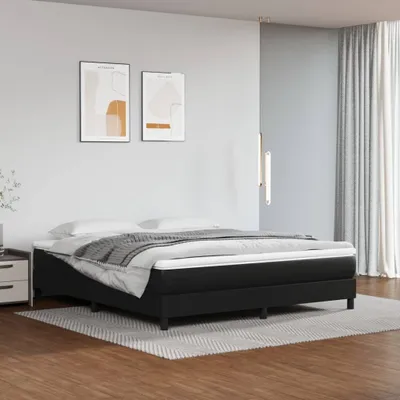 A bedroom scene featuring a black bed with white bedding.