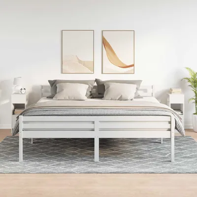A bedroom scene with a white bed and two white nightstands.