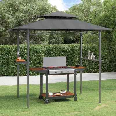 A grill gazebo set up in a backyard with a grill and accessories.