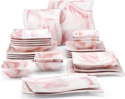 A collection of pink and white marbled ceramic dishes arranged on a white background.