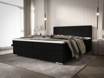 A bedroom scene featuring a large black bed.