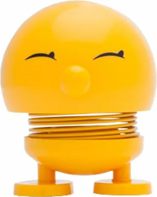 A yellow bobblehead toy with a spring in its neck.