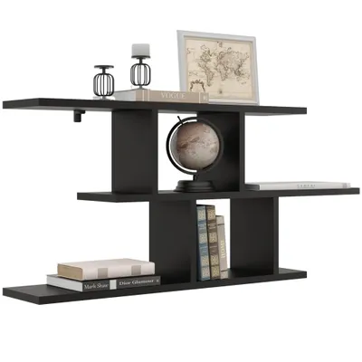 A black floating shelf with decorative items on it.