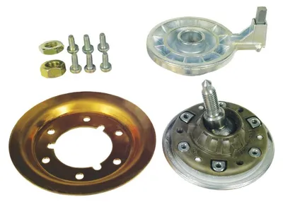 A collection of washing machine drum parts, including a bearing, shaft, and fasteners, laid out on a white background.