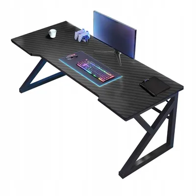 A gaming desk with a monitor, keyboard, mouse, and a cup.