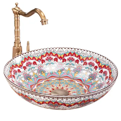 A decorative ceramic sink with a brass faucet.