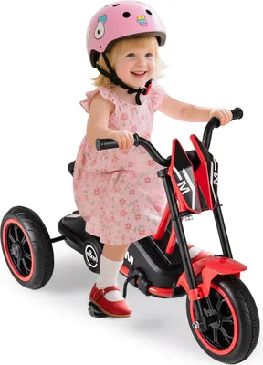 A young child is riding a red electric tricycle.