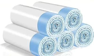 A stack of rolls of white garbage bags with blue bands.