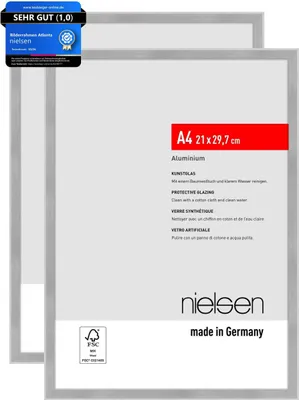 Two silver picture frames are shown, one slightly behind the other, on a light gray background. Text and logos are visible on the front frame.