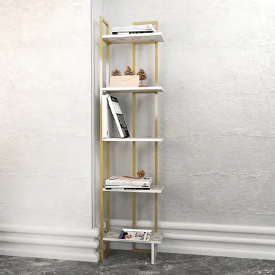 A tall, narrow bookshelf with gold-colored metal supports and white shelves, placed against a textured wall.