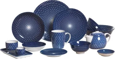 A collection of blue and white patterned dinnerware and drinkware is arranged on a white background.
