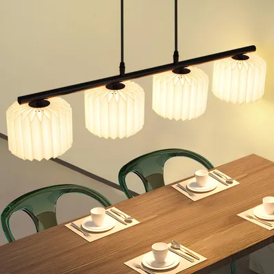 A dining table with chairs and a pendant light fixture above.