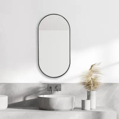 A modern bathroom vanity with a sink, faucet, and a wall mirror.