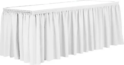 A white table skirt draped over a rectangular table.