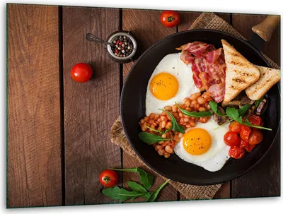 A cooked breakfast is served on a wooden table.