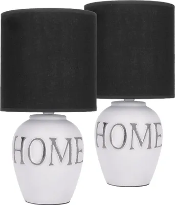 Two identical table lamps with black shades and white ceramic bases featuring the word "HOME" in gray.