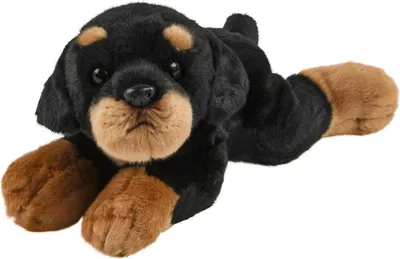 A plush toy dog lying down.