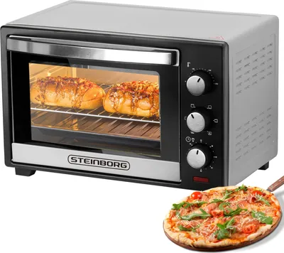 A Steinborg minibackofen with two loaves of bread inside and a pizza in the foreground.