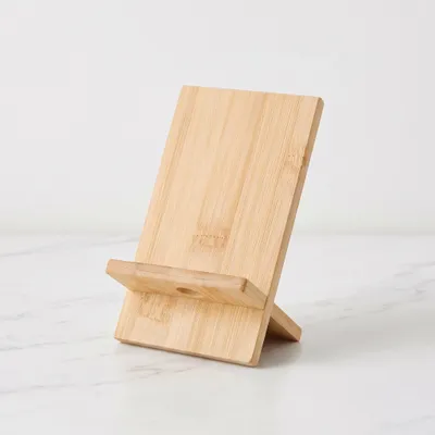 Immagine prodotto di QUVIO Supporto per telefono da tavolo - Supporto per telefono - Accessori per telefono - Supporto per smartphone - Marrone chiaro - Bambù - 8,5 x 8 x 12,5 cm, Immagine generata dall'IA