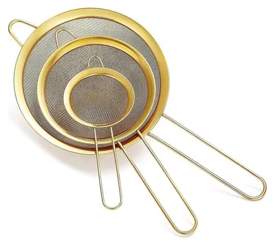 Three gold-colored sieves of different sizes are nested together and displayed against a white background.