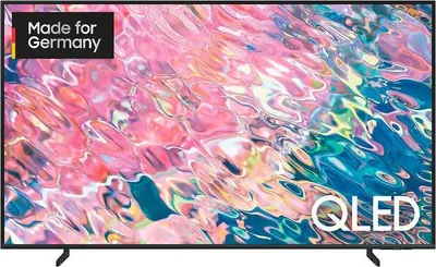 A Samsung QLED TV is shown from the front, displaying a colorful abstract image on its screen. The TV is black with thin bezels and stands on two black legs.