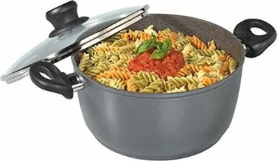A pot of pasta with sauce and basil on top, with the lid partially open.