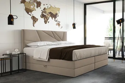A bedroom with a bed, bedside tables, and a world map decoration on the wall.