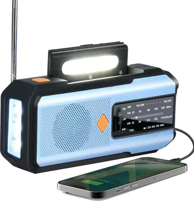 A portable emergency radio with a flashlight and a smartphone charging.