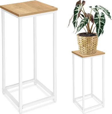 Two plant stands, one with a plant on it, against a white background.