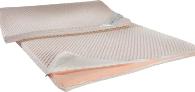 Two beige mattress toppers are shown, one on top of the other, with the bottom one partially unzipped to reveal a peach-colored interior.